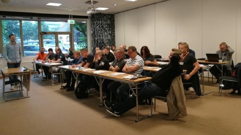 A classroom with employees from Certego learning about fire alarms.